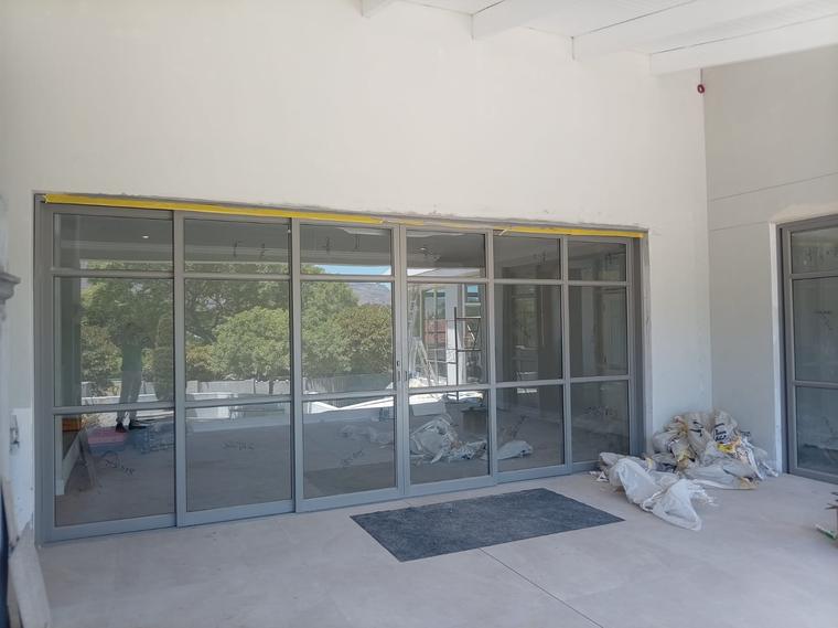 Newly installed grey aluminium shopfront-style glazed doors onto a terrace